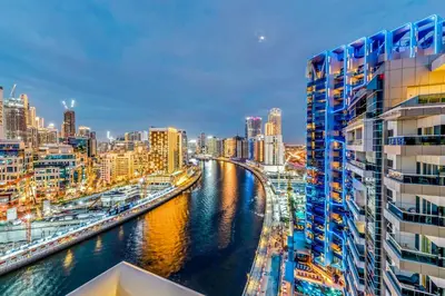 a river in a city with tall buildings at Burj Khalifa & Canal Views at Mayfair Tower in business bay - Luxurious 1BDR Apartment in Dubai