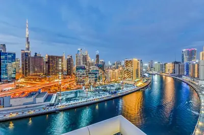 a view of a city with a river and buildings at Burj Khalifa & Canal Views at Mayfair Tower in business bay - Luxurious 1BDR Apartment in Dubai