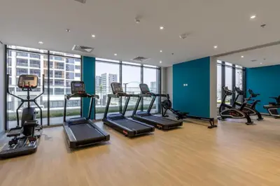 a gym with a bunch of exercise bikes in a building at Community View Studio with Balcony, Azizi Riviera 24, Al Merkadh by Deluxe Holiday Homes in Dubai