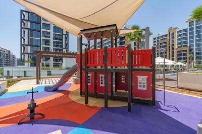 a playground in a city with a slide at Community View Studio with Balcony, Azizi Riviera 24, Al Merkadh by Deluxe Holiday Homes in Dubai