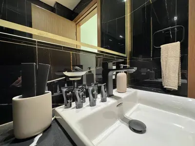 a bathroom with a white sink and a mirror at Stylish 1br With Garden View In Jvc in Dubai