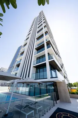 a tall white building with a lot of windows at Stylish 1br With Garden View In Jvc in Dubai