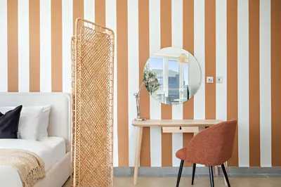 a bedroom with a mirror and a chair and a bed at Silkhaus Cozy Studio at Madison in Barsha Heights in Dubai