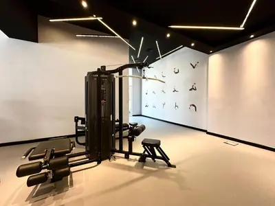 a room with a gym with a treadmill at Silkhaus Cozy Studio at Madison in Barsha Heights in Dubai