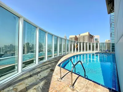 a balcony with a swimming pool on a building at Silkhaus Large Studio in Madison near Barsha Heights in Dubai