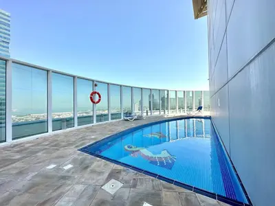 a swimming pool on the top of a building at Silkhaus Large Studio in Madison near Barsha Heights in Dubai