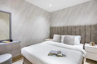 a bedroom with a large white bed and a mirror at Stylish 2-Bedroom in the Heart of OldTown Dubai in Dubai