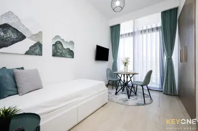 a bedroom with a bed and a dining room table at Modern Elegance Studio in Azizi Riviera in Dubai