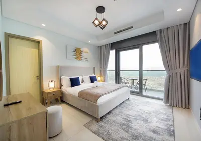 a bedroom with a bed and a view of the ocean at Opulent 2BR In Paramount Hotel Apt in Dubai