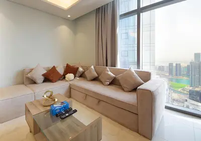 a living room with a couch and a large window at Opulent 2BR In Paramount Hotel Apt in Dubai