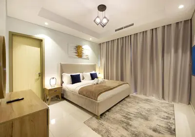 a bedroom with a bed and a dresser and a mirror at Opulent 2BR In Paramount Hotel Apt in Dubai