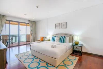 a bedroom with a large bed and a balcony at RH -Luxury Living, Full Sea View Apartment on palm in Dubai