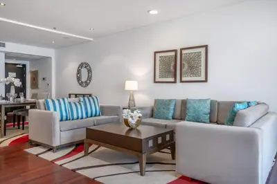 a living room with a couch and a table at RH -Luxury Living, Full Sea View Apartment on palm in Dubai
