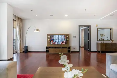 a living room with a television and a couch at RH -Luxury Living, Full Sea View Apartment on palm in Dubai
