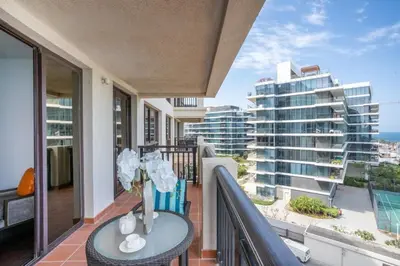 a balcony with a table and a view of a building at RH -Luxury Living, Full Sea View Apartment on palm in Dubai