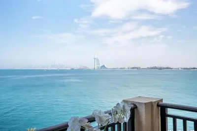 a balcony with a view of the water and a building at RH -Luxury Living, Full Sea View Apartment on palm in Dubai