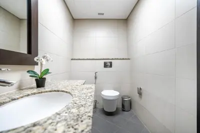 a bathroom with a sink and a toilet at RH -Luxury Living, Full Sea View Apartment on palm in Dubai