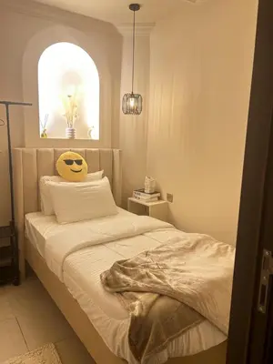 a bedroom with a bed with a smiley face on it at Adaz Home in Dubai
