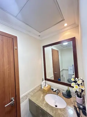 a bathroom with a sink and a large mirror at Adaz Homes in Dubai