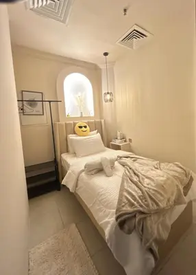 a bedroom with a bed and a window at Adaz Homes in Dubai