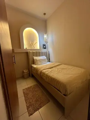 a small bedroom with a bed and a window at Adaz Homes in Dubai