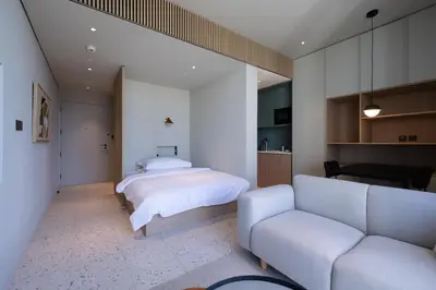 a bedroom with a bed and a couch at Modern Studio at Upside Living with Burj Views - Business Travelers in Dubai