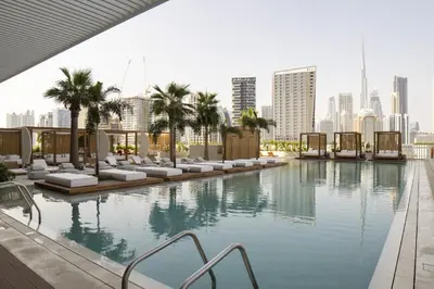a swimming pool with a city skyline in the background at Modern Studio at Upside Living with Burj Views - Business Travelers in Dubai