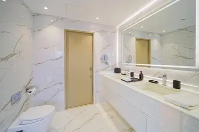 a white bathroom with a sink and a toilet at Luxurious Apartment And Amazing Dubai Marina View in Dubai
