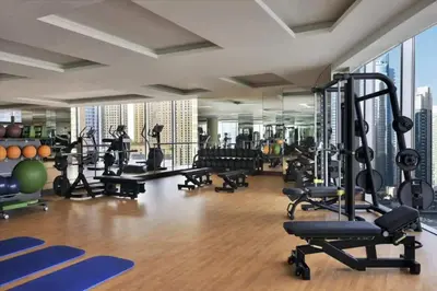 a gym with a lot of treadmills and machines at Luxurious Apartment And Amazing Dubai Marina View in Dubai