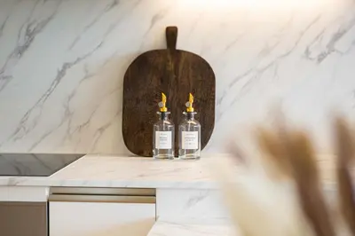 two bottles of whiskey sitting on a counter in a kitchen at Luxurious Apartment And Amazing Dubai Marina View in Dubai