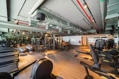 a gym with a lot of treadmills and machines at Luxury 2BHK Plus Maid's Room The Sterling West Near Dubai Mall in Dubai