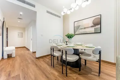 a dining room with a table and chairs at Upgraded 2BR with Partial Sea and City Views Near the Beach, Elite Residence, Dubai Marina by Deluxe Holiday Homes in Dubai