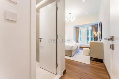 a room with a glass door leading to a bedroom at Upgraded 2BR with Partial Sea and City Views Near the Beach, Elite Residence, Dubai Marina by Deluxe Holiday Homes in Dubai