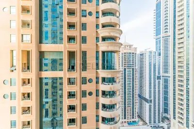 a tall building in a city with tall buildings at Upgraded 2BR with Partial Sea and City Views Near the Beach, Elite Residence, Dubai Marina by Deluxe Holiday Homes in Dubai
