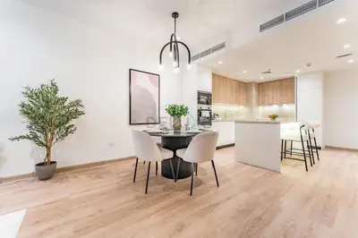 a kitchen and dining room with a table and chairs at Renovated 1BR with Partial Sea and City Views Close to the Beach, Elite Residence, Dubai Marina by Deluxe Holiday Homes in Dubai