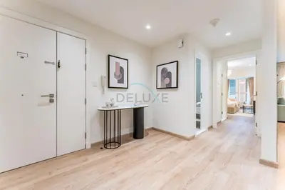 a white hallway with a table in a room at Renovated 1BR with Partial Sea and City Views Close to the Beach, Elite Residence, Dubai Marina by Deluxe Holiday Homes in Dubai