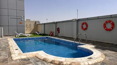 a swimming pool on the side of a building at Cozy 1Bed Sports city in Dubai