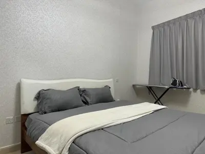 a bedroom with a bed with two pillows on it at Cozy 1Bed Sports city in Dubai
