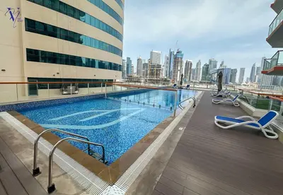 a swimming pool on the roof of a building at Luxurious 2-Bedroom Haven in Dubai
