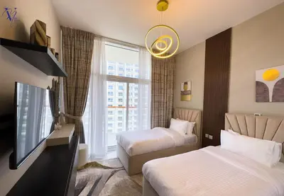 a hotel room with two beds and a window at Luxurious 2-Bedroom Haven in Dubai