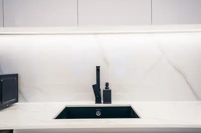 a black sink in a white counter top at Luxury 2 bedroom Unit, Prime Location in Dubai