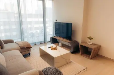 a living room with a couch and a tv at Luxury 2 bedroom Unit, Prime Location in Dubai