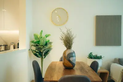 a dining room table with a vase on top of it at Luxury 2 bedroom Unit, Prime Location in Dubai