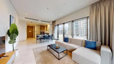 a living room with a couch and a table at Peninsula - Modern Two Bedroom in Business Bay in Dubai