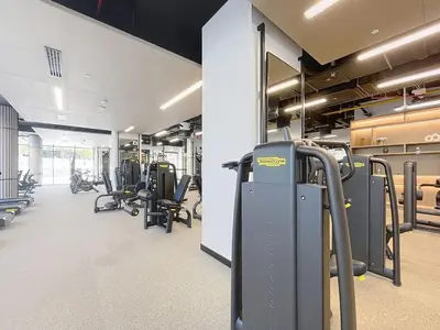 a gym with treadmills and machines in a room at Peninsula - Modern Two Bedroom in Business Bay in Dubai