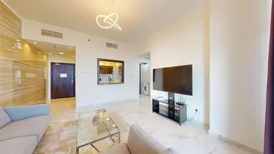 a living room with a couch and a flat screen tv at Torch Tower - One Bed with Skyline View in Marina in Dubai