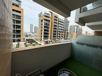 a balcony with a view of a city with tall buildings at Meydan Riviera Midtown Comfort Studio in Dubai