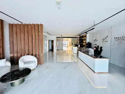 a lobby of a building with a table and chairs at Al Manara Classic Luxe Studio in Dubai