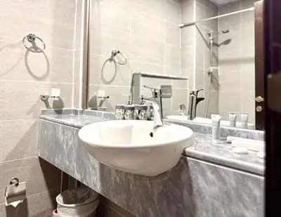 a bathroom with a sink and a mirror at Al Manara Premium Cozy Studio in Dubai