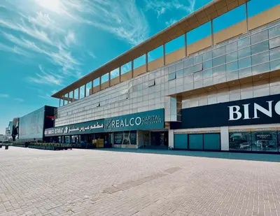 a large building with a brick road in front of it at Al Manara Premium Cozy Studio in Dubai